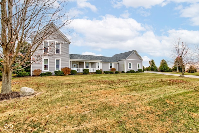 view of front of home with a front yard and covered porch