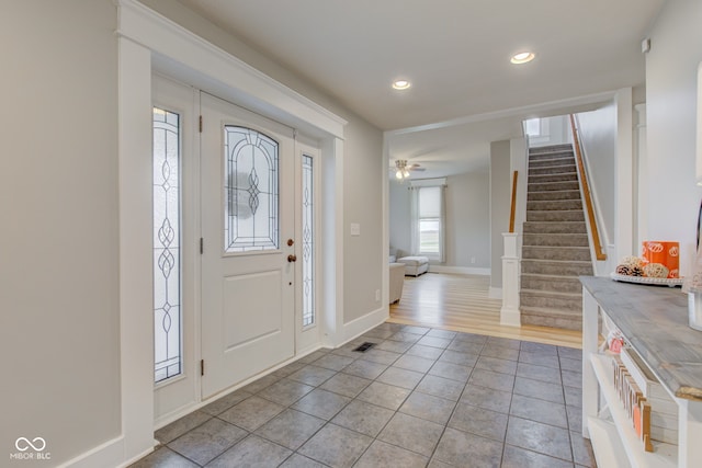 foyer entrance with light wood-type flooring and ceiling fan