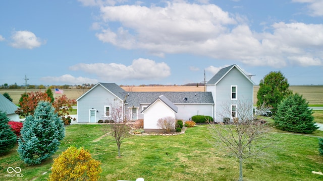 rear view of property featuring a yard