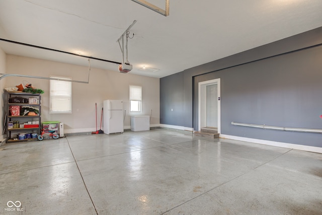 garage with white fridge and a garage door opener