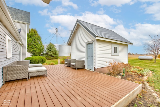 wooden deck with an outbuilding and an outdoor hangout area