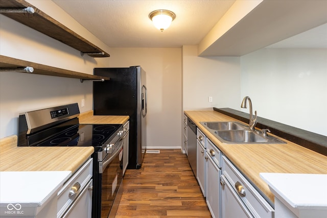 kitchen featuring gray cabinetry, sink, stainless steel appliances, and dark hardwood / wood-style floors