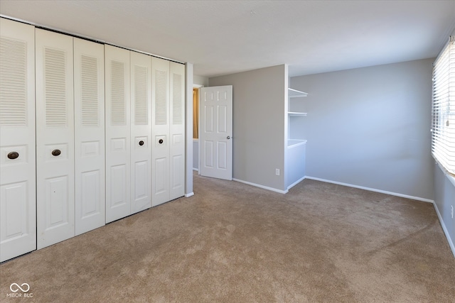 unfurnished bedroom featuring carpet floors and a closet