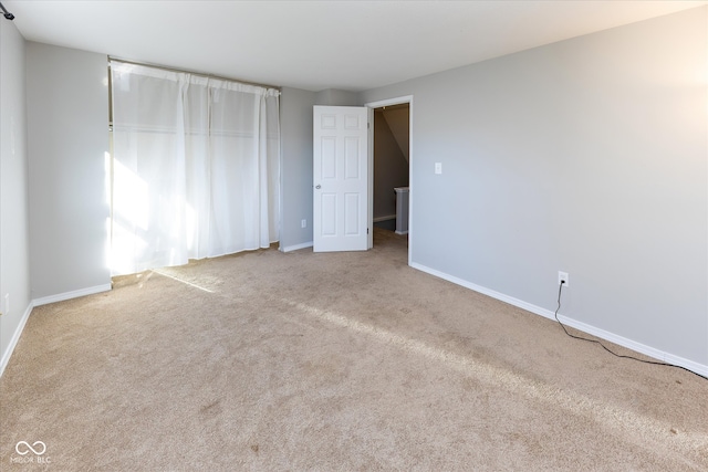 unfurnished bedroom featuring light carpet