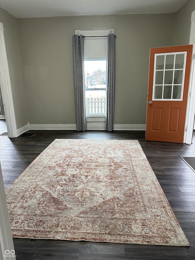 empty room featuring dark hardwood / wood-style flooring