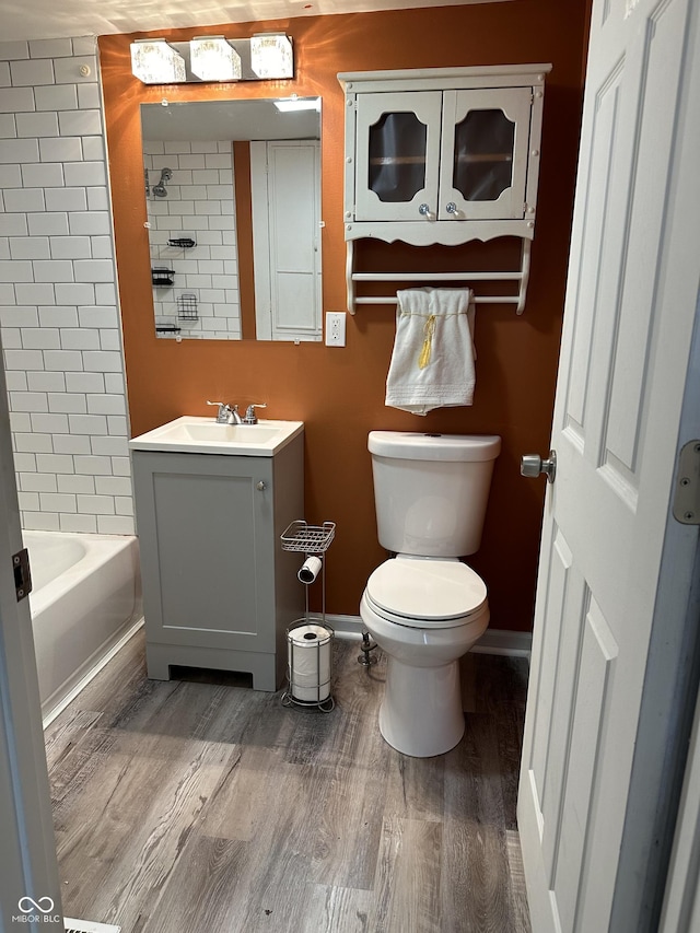 bathroom featuring vanity, hardwood / wood-style floors, and toilet