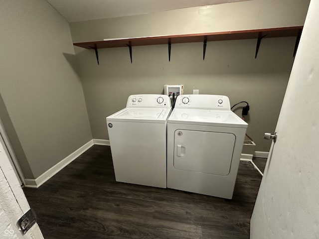 laundry area featuring washing machine and dryer and dark hardwood / wood-style floors