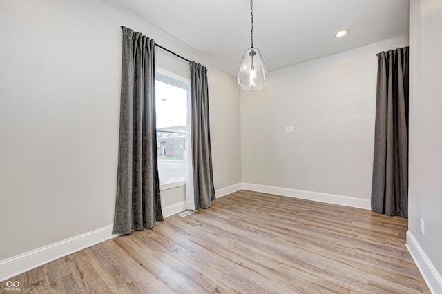 unfurnished room with light wood-type flooring