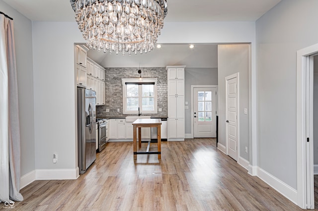 kitchen featuring light hardwood / wood-style flooring, white cabinets, appliances with stainless steel finishes, and sink