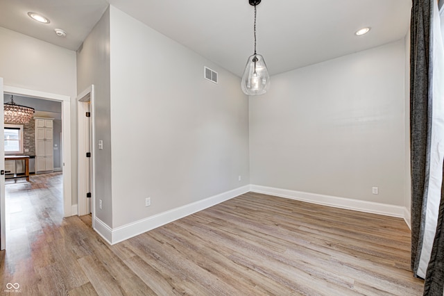 unfurnished dining area featuring light wood-type flooring