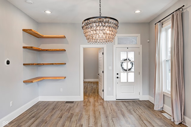 entrance foyer featuring a chandelier and light hardwood / wood-style floors