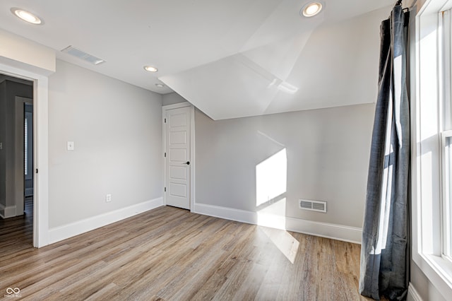 bonus room featuring light hardwood / wood-style flooring and lofted ceiling