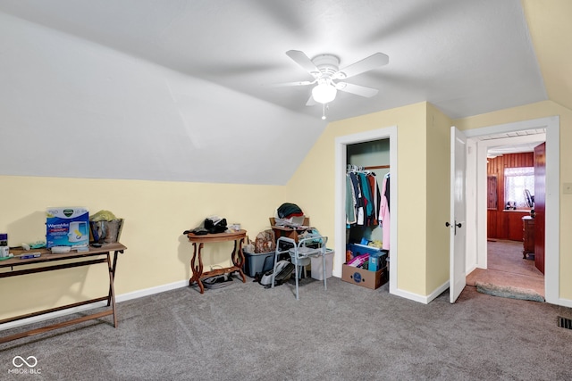 interior space with ceiling fan, lofted ceiling, and carpet