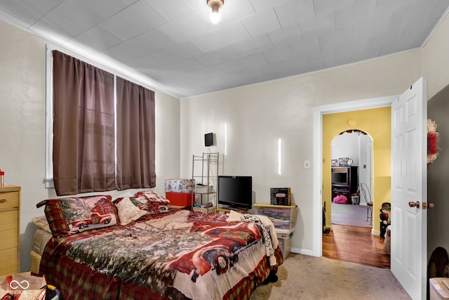 carpeted bedroom with ornamental molding