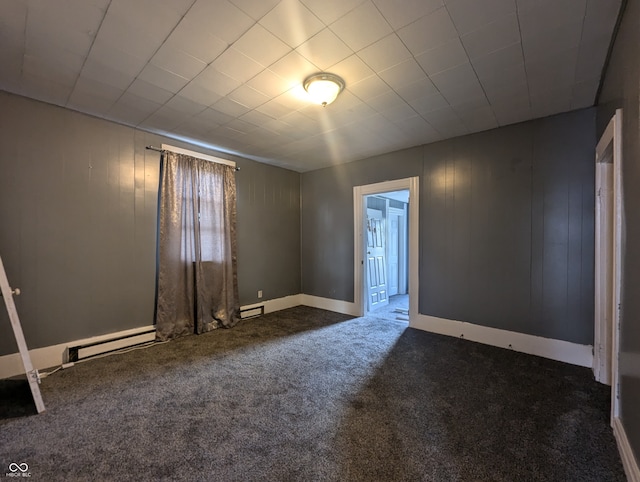 carpeted empty room with baseboard heating