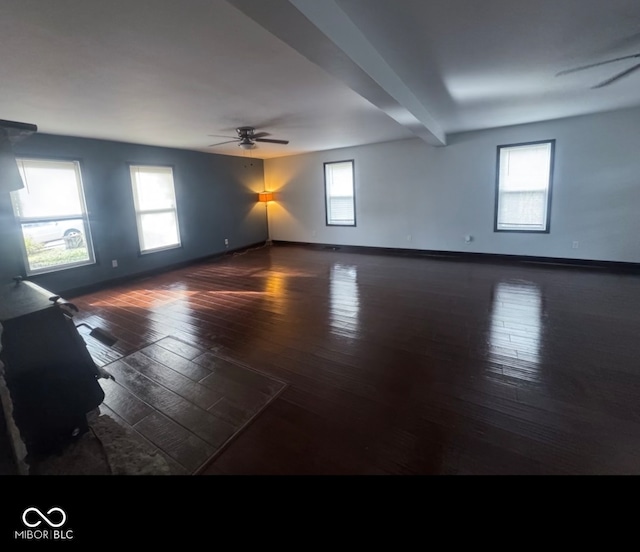 unfurnished room featuring dark hardwood / wood-style flooring, a wealth of natural light, and ceiling fan