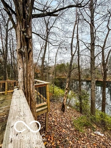 view of yard with a deck with water view