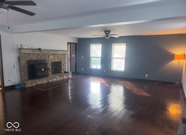 unfurnished living room with beam ceiling, ceiling fan, and dark hardwood / wood-style floors