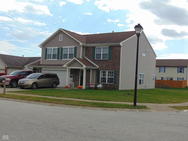 view of front of property featuring a garage and a front yard