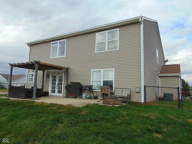 back of property with a patio, a pergola, a fire pit, and a yard