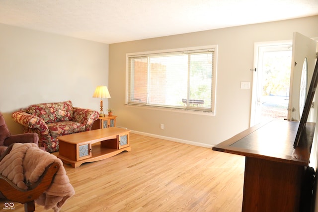 living room featuring light hardwood / wood-style flooring and a textured ceiling