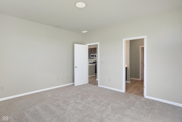 unfurnished bedroom with light carpet