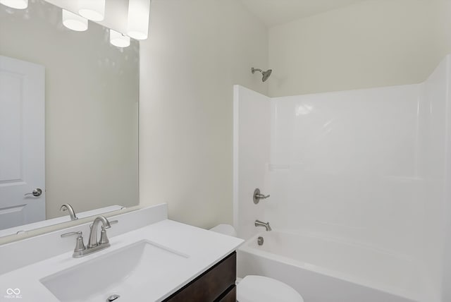 full bathroom featuring tub / shower combination, vanity, and toilet