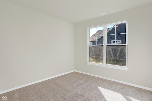 spare room with light colored carpet