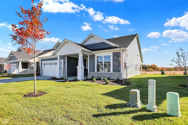 view of front of house featuring a garage and a front lawn