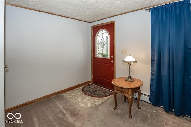 carpeted foyer featuring a baseboard heating unit, a textured ceiling, and crown molding