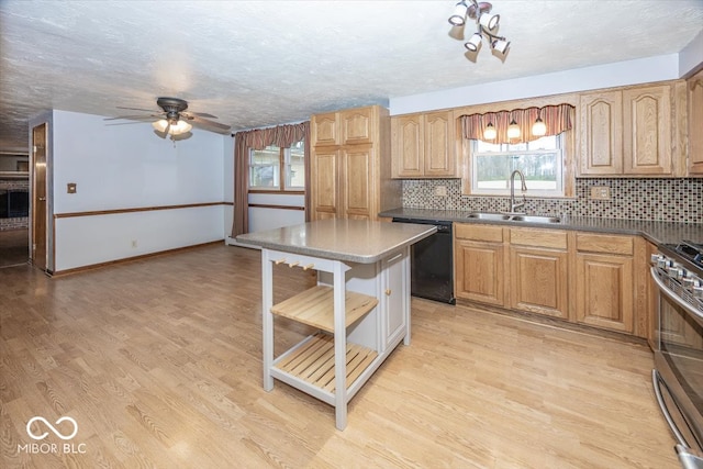 kitchen featuring backsplash, stainless steel range with gas cooktop, sink, dishwasher, and light hardwood / wood-style flooring