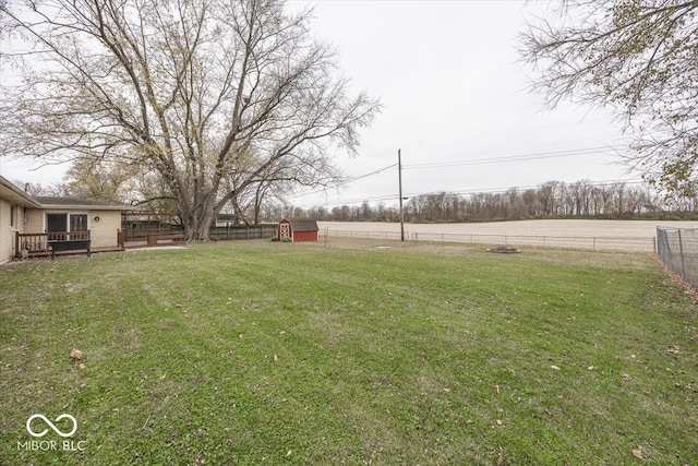 view of yard with a deck and a shed