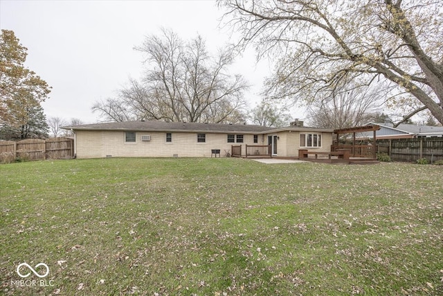 back of property featuring a deck and a lawn