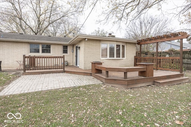 rear view of house featuring a patio, a lawn, and a wooden deck