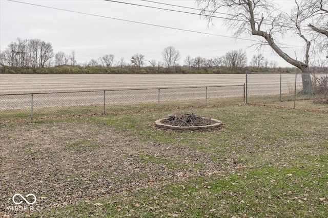 view of yard with a rural view and a fire pit