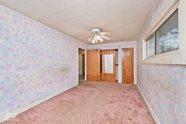 carpeted empty room featuring ceiling fan