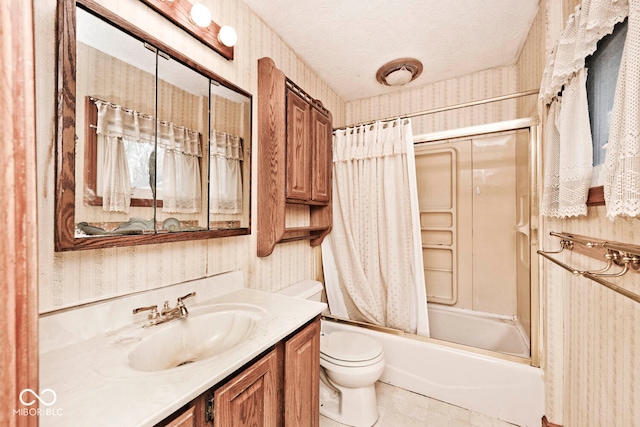 full bathroom featuring shower / tub combo with curtain, vanity, toilet, and a textured ceiling