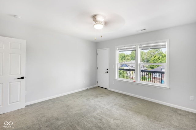 carpeted empty room featuring ceiling fan