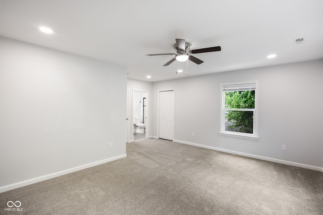 spare room with carpet and ceiling fan