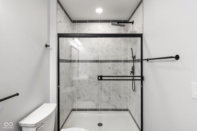 bathroom with toilet and walk in shower