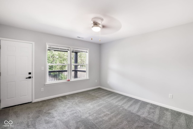 empty room with ceiling fan and carpet floors