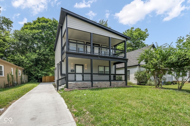 view of front facade with a porch, a front lawn, and a balcony