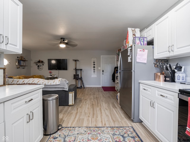 kitchen with white cabinetry, appliances with stainless steel finishes, ceiling fan, and light hardwood / wood-style floors