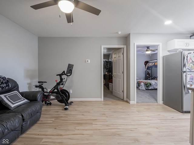 workout room with light hardwood / wood-style flooring