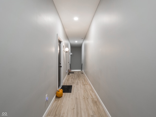 hallway with light hardwood / wood-style floors