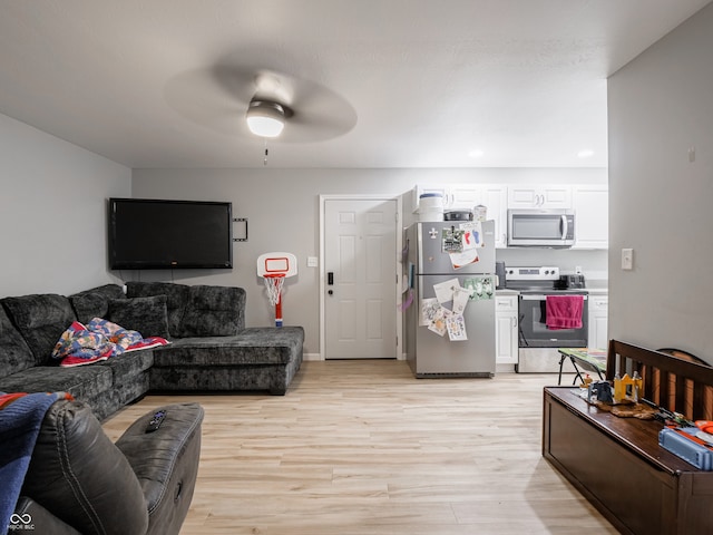 living room with light hardwood / wood-style flooring and ceiling fan