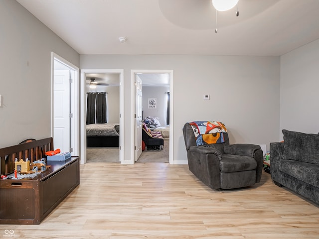 living room with ceiling fan and light wood-type flooring