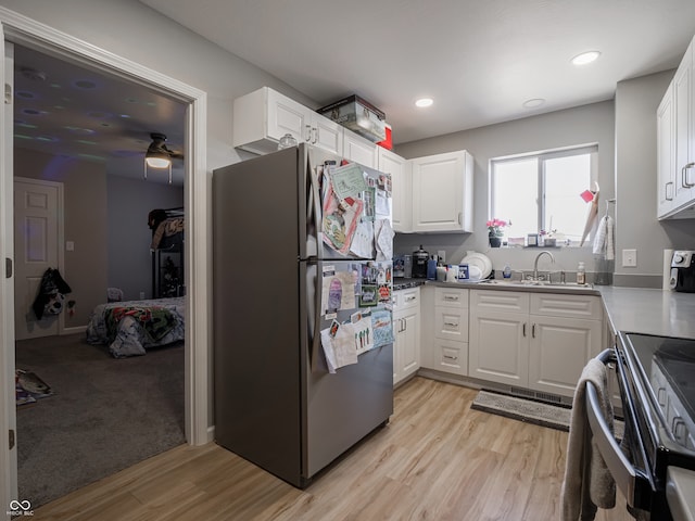 kitchen featuring light hardwood / wood-style flooring, appliances with stainless steel finishes, ceiling fan, and white cabinets