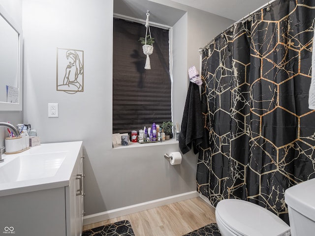 bathroom with toilet, vanity, wood-type flooring, and curtained shower