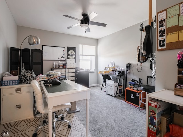 carpeted office featuring ceiling fan